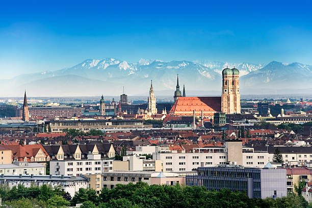 Munich, capital city of Germany's Free State of Bavaria. CIty skyline in the evening light. The Alps visible in the background.